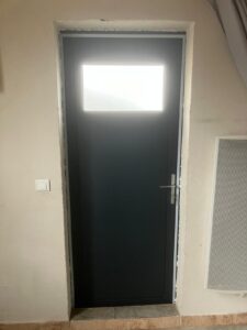 Porte noire avec fenêtre sur le dessus.